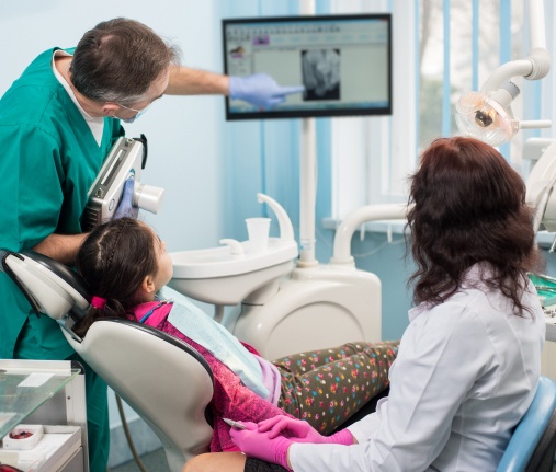 doctor pointing at x-rays with patient